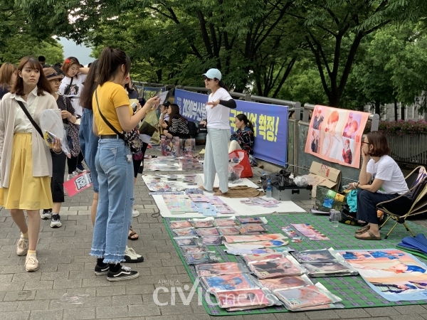 16일 부산 아시아드 보조경기장에서 방탄소년단 콘서트가 열린 가운데 공연장으로 향하는 육교에서 상인들과 팬들이 방탄소년단 굿즈를 판매하고 있다(사진: 취재기자 신예진).